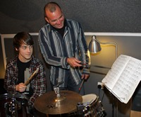 Rossini Cavalcante working with student Forest at the Drum Kit